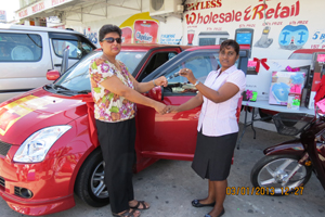 ... ) receives the keys to her new Suzuki Swift from a Payless employee