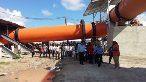 Dr. Safeek and his family, as well as PM Hinds; Mr. Armogan; the Contractor; Mr. Haywood and other staff pose against the backdrop of the cement- manufacturing facility yesterday.