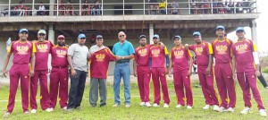 Managing Director of ND&S Furniture Store, Sham Mahadeo (blue shirt), hands over a jersey to CCC captain Randy Persaud and President Gobin Persaud in the presence of other members of the team. 