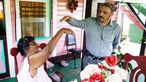 Health Minister assists in performing hand exercises on Ramcharran
