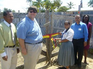 Mr Bryan Hunte and Ken Vincent Ms. Joseph and the Headteacher at left assist in cutting the ribbon to commission the Lower Corentyne Secondary School farm.