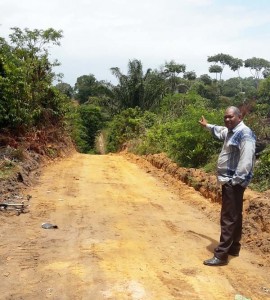 IMC Chairman, Ovid Benjamin points to the ongoing road project.