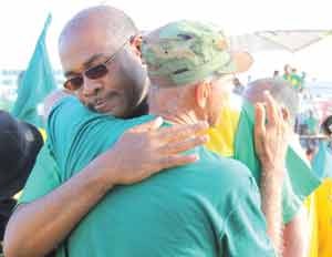 Nigel Hughes is greeted by prominent Essequibo businessman Sam Bacchus