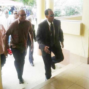Former President Bharrat Jagdeo [left) makes his way to the Magistrate's Court