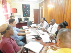 MPs Valerie Adams [right) and Jermaine Figueira (far right) flank Region 10 Chairman, Renis Morian, at the meeting with Bosai officials yesterday.