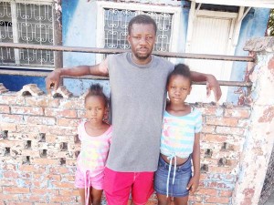 Marlon Trim and his two daughters who lost everything in the fire.