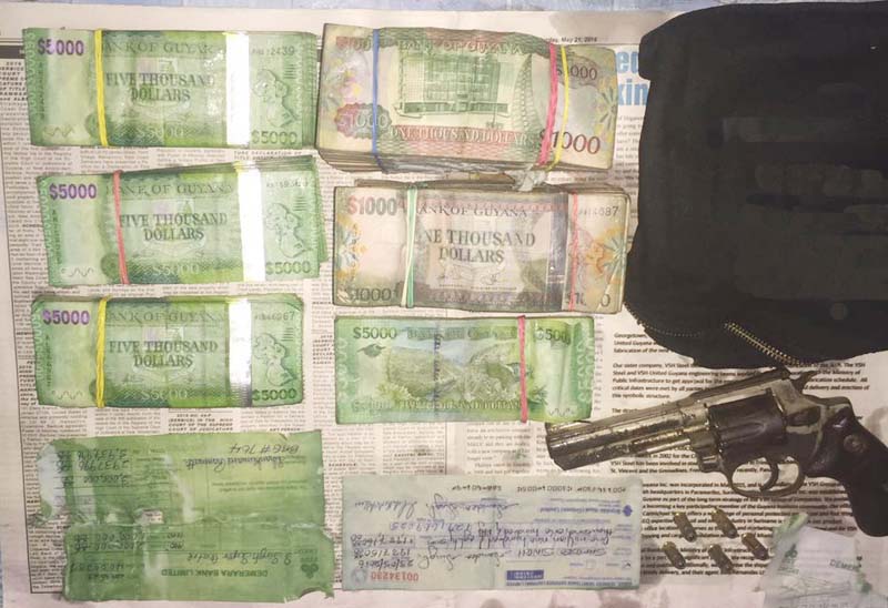 The recovered cash and one of the firearms.