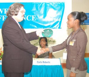 Kenesha Collins, Best Graduating Student with a Diploma in Banking and Finance receives her plaque from Republic Bank’s Senior Credit Manager, John Alves.