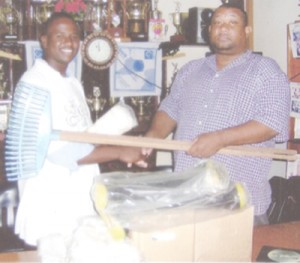 Sydney Cort (left) accepting the donation from Hilbert Foster.