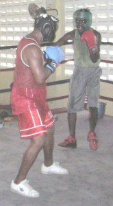 TURNING BACK THE HANDS OF TIME: Veteran boxer, Clifford ‘Piggy’ Griffith (left) engages a much younger Cecil Smith during sparring sessions yesterday morning.