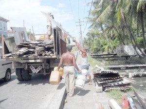 A Public Works truck being loaded with the squatters’ building materials