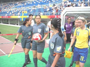Dianne Ferreira James (centre) heads on field during a match during the Beijing Olympics.