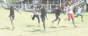 Rhondel Adams (second, left) leans for a thrilling finish ahead of Kenneth Semple (third, left) and Rawle Greene (fourth, left) respectively after Greene strained a quad muscle on the finish line.