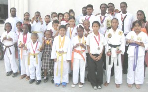 Outstanding!!! Some athletes from the Harpy Eagles Martial Arts Academy pose for Kaieteur Sport yesterday with their replicas and medals.