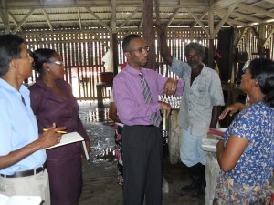Commissioner Keith Burrowes converses with vendors.  Standing at left is Mr Puran Persaud and Ms Yonette Pluck