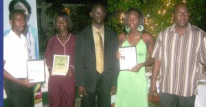 OUTSTANDING!!! Parliamentary Secretary, Steve Ninvalle  (right) and AAG President, Colin Boyce (third, right) pose  with the outstanding awardees Friday night at Olympic House.  From left are Cleveland Forde, Jenella Jonas and Alika Morgan.