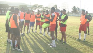 Alpha’s captain Charles Pollard has the attention of his colleagues after their practice session at the Guyana Defence Force ground on Saturday afternoon. 