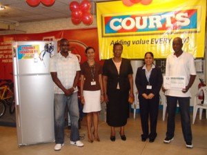 Courts PRO, Zeya Nasir-Ramnauth (second from right) poses with representatives of the GRC and the Courts Pacesetters Basketball team.