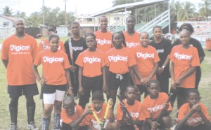 Digicel's Retail Sales Manager Dwayne Scott (extreme left) poses with junior hockey  players from Linden shortly after presenting them with jerseys last Tuesday. 