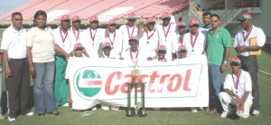 The victorious Georgetown Under-15 team pose with the winningtrophy and representatives on sponsor Castrol yesterday.