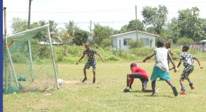 Groves’ Mervin Squires (No. 8 - right) firing in another goal against Samatta Point in their clash yesterday at the Grove ground. 