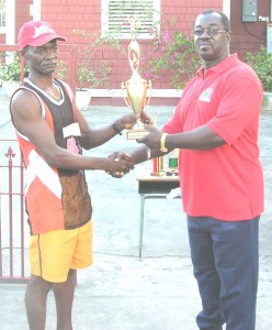 Rudolph Mitchell (left) collects his trophy from Frank Tucker.