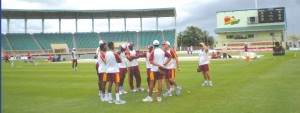 WI players and  Coach John Dyson (right) talk strategy during practice.
