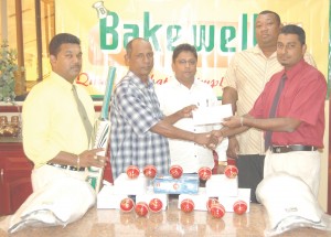 Bakewell Accountant Imran Ally (right) handing over the cheque to RHTY&SC Assistant Organising Secretary Ravindranauth Kissoonlall. Others in photo from left, Bakewell’s Personnel Assistant Bisram Dubraj, Rajin Ganga and Hilbert Foster. (Franklin Wilson Photo) 