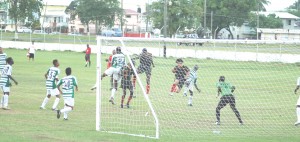 CLOSE CALL!!! Ron Fiedtkou’s (3rd right) header which seems goal bound but was tipped over the bar by the alert Suriname GK, Obremao Huibwoud. (Franklin Wilson photo)  