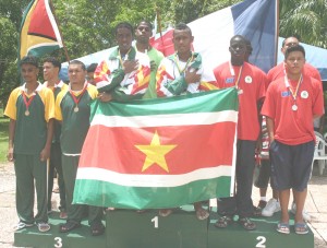 Members of the winning Surinamese swim team (centre) on the podium after triumph in a relay event.