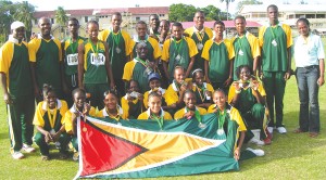 WE ARE THE CHAMPIONS!!! Guyana's triumphant IGG athletics team pose for Kaieteur Sport  following their emphatic overall track and field win at the Police Sports Club Ground yesterday.