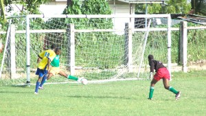 Pele’s Sheldon Holder (left) about to complete  his hat-trick against Uprising yesterday.