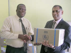 Health Minister, Dr. Leslie Ramsammy, receives  a portion of the medication from Pastor Isaacs. 