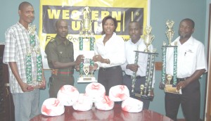 Western Union’s Marketing Manager Natheeah King (centre) handing over the cheque and champions trophy to GFA 1st VP, Captain Tyrone Smith. Displaying the other trophies from right are, Vaughn Alleyne, Marlan Cole, and Lyall Gittens. 
