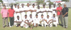 GCB head Chetram Singh (left) and GTM’s Edward Persico (right) with the victorious Berbice cricket team after they retained the GTM One-Day U-19 Inter-County title at DCC yesterday. 