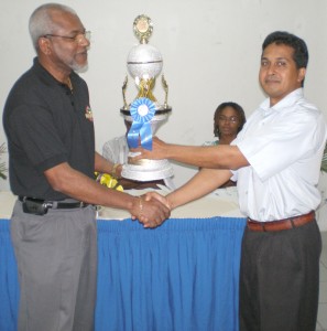 Scrabble champion Frederick Collins (left) seen collecting the 2007 National C/ship trophy.