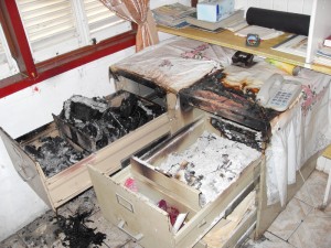 The charred documents and  the damaged filing cabinet