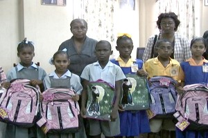 Students of St. Stephens and West Ruimveldt primary  schools after collecting some of the haversacks 