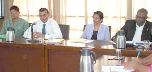  James Singh, Commissioner of Forests, Minister of Agriculture Robert Persaud,  and other officials of the Forest Products Development and Marketing Council yesterday at the conference centre 