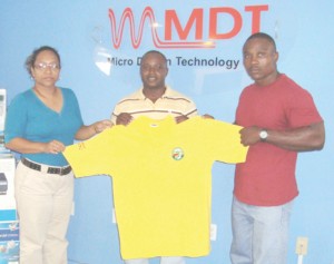 Marketing Executive of MDT Ms. Culpepper (left) displays the polo shirt along with Randolph Morgan (right) and Mervin Moses. 