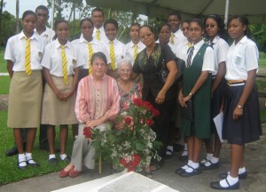  Keeping Literature alive. Remembering Martin Carter at his grave side:  Students of Queens College, The Bishops High School and Central High school and their  teacher Phyllis Jordan, flank Martin Carter’s wife. Sitting left is Dr Joyce Jonas.  
