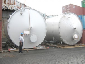 GPL CEO Bharrat Dindyal standing by two of the fuel storage tanks that will supply the three generators. 