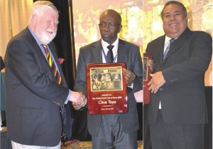 Clive Toye left accepts his Plaque from President Warner while, Julio Rocha (right) had also collected the Hall of Fame Plaque.