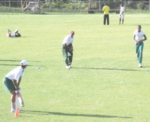 GRASS PRACTICE! Jonathon Foo bats against Andre Stoll as the Guyana U-19 cricketers had to resort to ‘shot knocks’ on the grass at the Police ground.