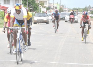 Warren ‘Forty’ Mc Kay crosses the finish line comfortably ahead of Robin Persaud, Junior Niles (partly hidden) Eric Sankar and Horace Burrowes yesterday in Berbice. (Franklin Wilson photo) 