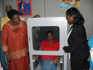 Dr Ruth Quaicoe (at right) examines a patient in  the booth along with Dr Claudette Heyliger-Thomas