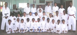 The group of Karatekas poses for a photo op with Sensies Ramnarine (extreme right, standing) and Henry (extreme left) shortly after the completion of the grading sessions.
