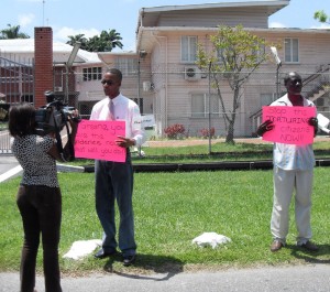 Mark Benschop (left) and Norris Witter during  their protest at Office of the President yesterday. 