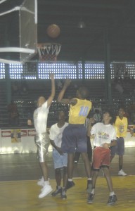 Selvaughn Moseley (#!0) executes a jump shot while being challenged by Pritipaul Singh (let).