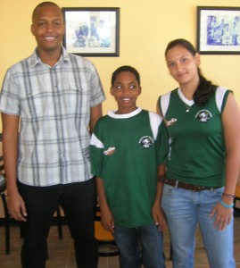 Managing Director of German’s Restaurant Clinton Urling (left) poses with junior Squash players Nyron Joseph and Alysa Xavier shortly after presenting them with sponsorship cheques last Wednesday.